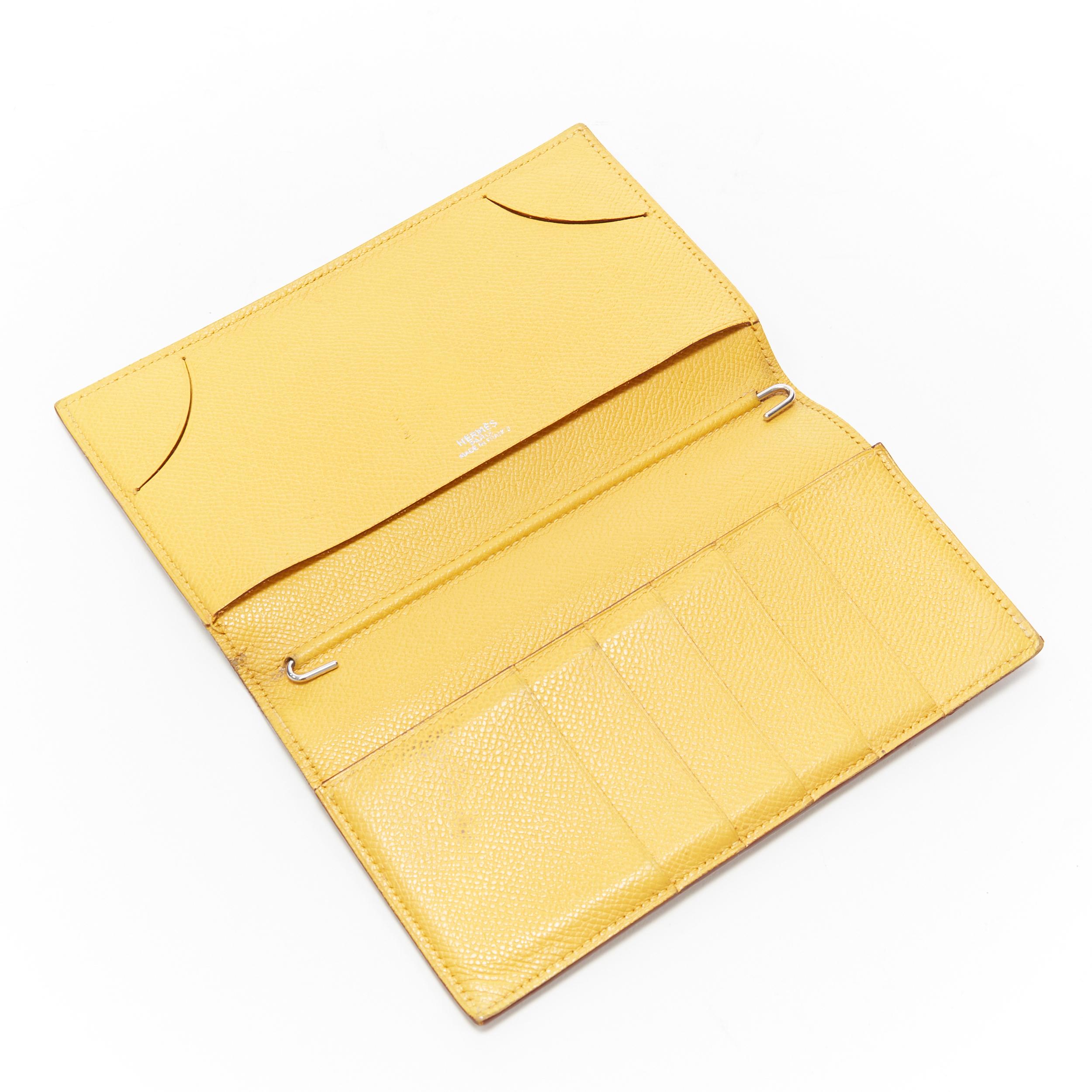 HERMES tan leather contrast yellow lining minimal long bi fold wallet 
Reference: UIHG/A00002 
Brand: Hermes 
Material: Leather 
Color: Brown
Pattern: Solid 
Extra Detail: Contrast yellow lining on outer. 
Made in: France 

CONDITION: 
Condition: