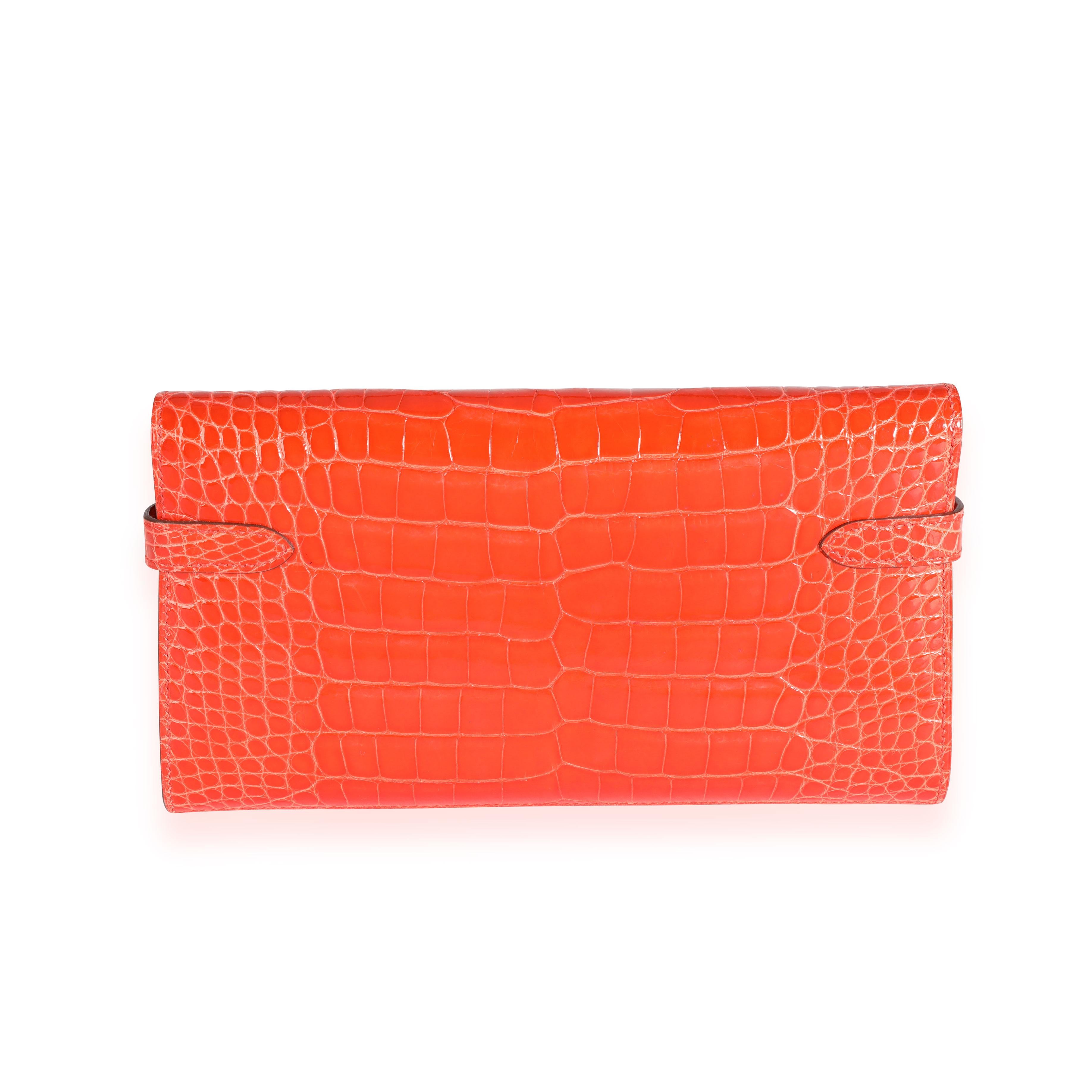 Listing Title: Hermès Tangerine Shiny Alligator Classic Kelly Wallet GHW
SKU: 111840
MSRP: 14800.00
Condition: Pre-owned (3000)
Handbag Condition: Very Good
Condition Comments: Very Good Condition. Scratching to hardware. Please note: this item can