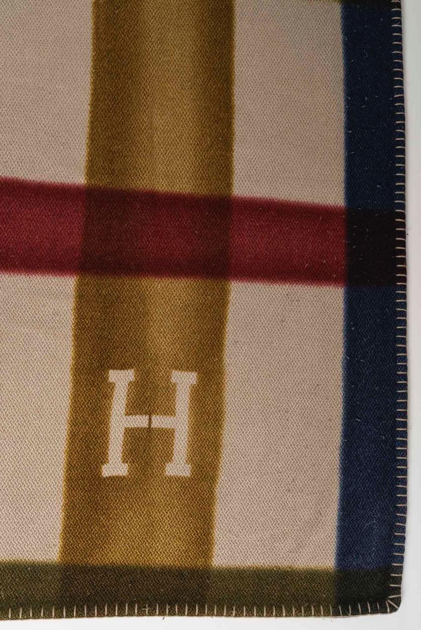 
Hand-spun and hand-woven cashmere throw

- 100% Mongolian cashmere
- Hand-dyed
- Saddle-stitch finish

The plaid is first woven by hand, revealing two large vertical stripes of color. It is then dipped in two different dye baths at each end.
The