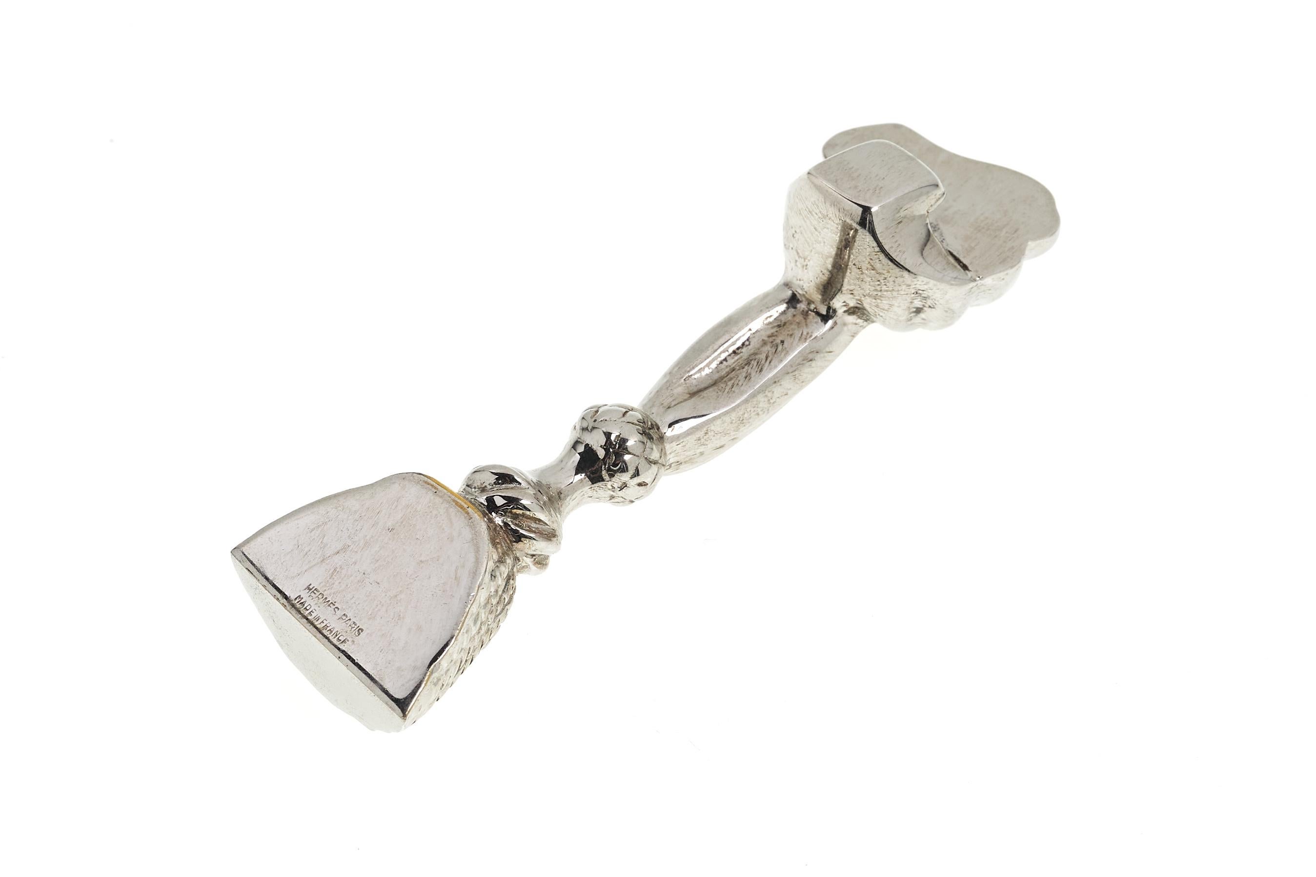A fine and elegant bottle opener by Hermes, in the form of a curtain tassel. Marked on interior handle.

Measures: 4