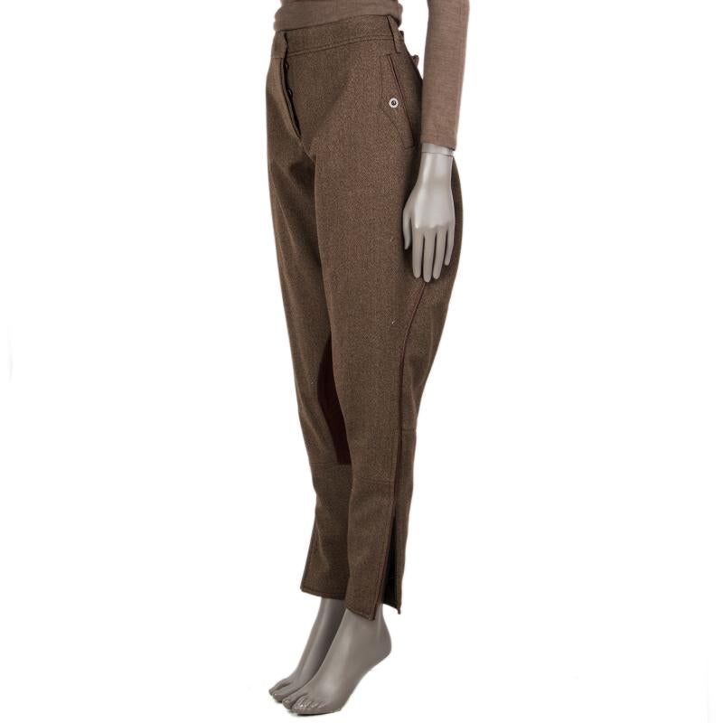 100% authentic Hermes jodphur breeches in taupe and off-white virgin wool (100%) and cognac lambskin. With belt loops, two snap welt pockets on the front, one on the back, cinching belt on the back, piping trims, inner-leg patches, and zippered