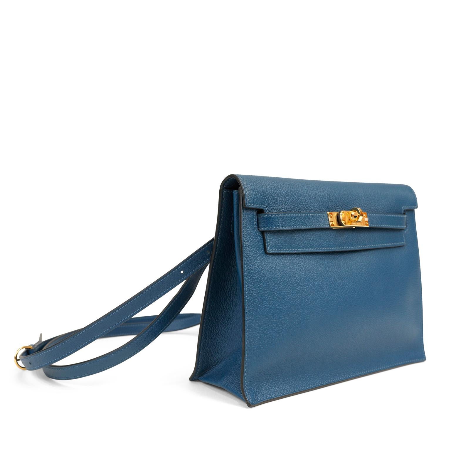 This authentic Hermès Teal Blue Evercolor Kelly Danse II is in pristine unworn condition with the protective plastic intact on the gold hardware.  Extremely versatile, The Kelly Danse II may be carried on the shoulder, across the body or as a chic