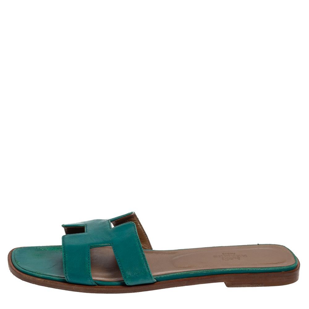 Put your best foot forward this season in these pretty Hermes sandals. These Oran slides have been crafted from leather in Italy in teal green color, and they feature the iconic H on the vamps and insoles meant to provide comfort at every step.