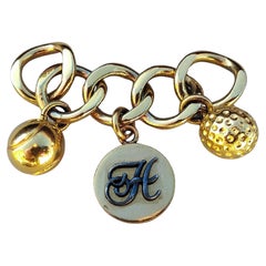 Portachiavi con charm a forma di palline da tennis e da golf di Hermès