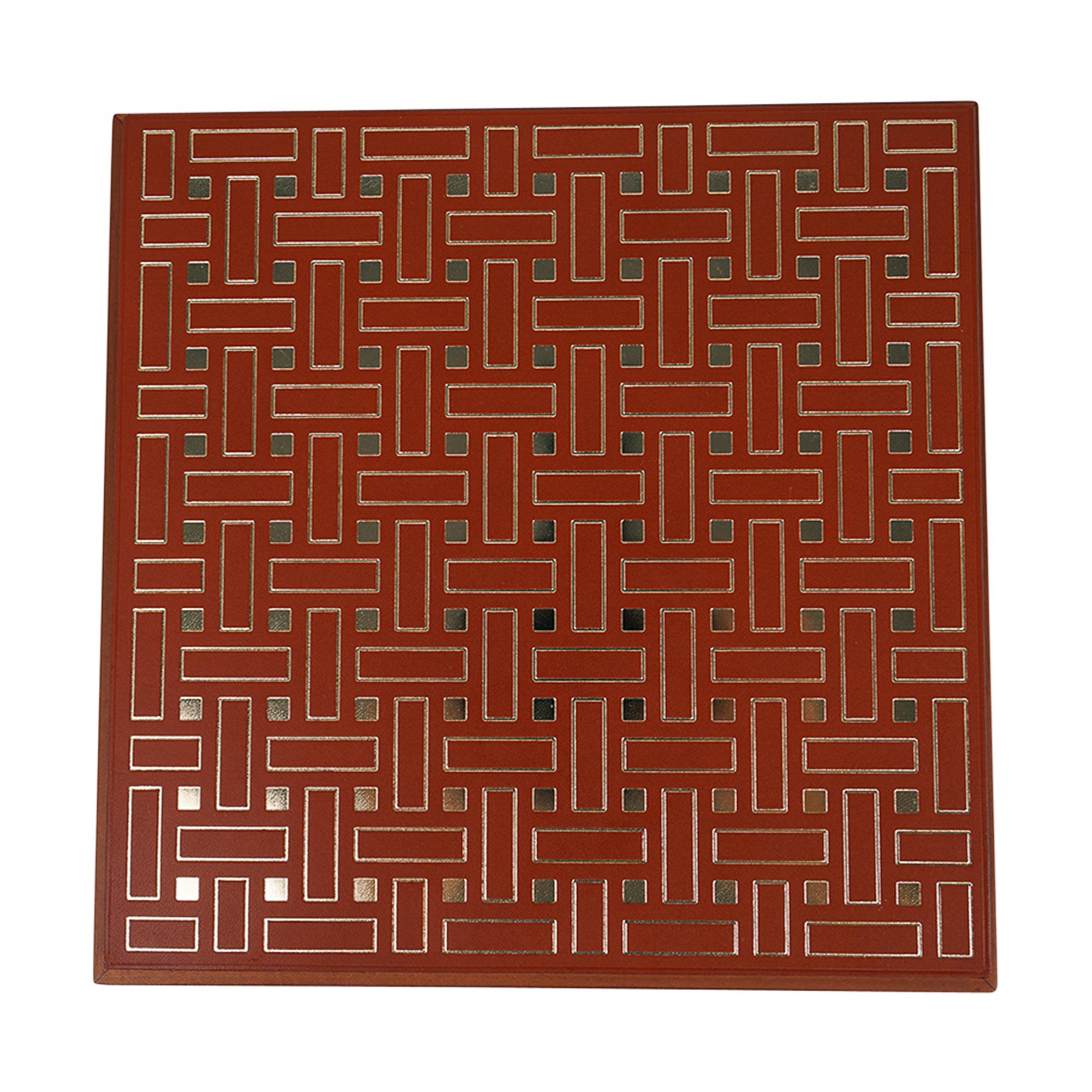 Mightychic offers an Hermes Theoreme Mosaique Or box featured in the Medium model.
Natural Mahogany wood with bridle leather lid sheets stamped with gold Mosaique motif in gold.
Bridle leather lid is hot foil stamped using traditional bookbinding