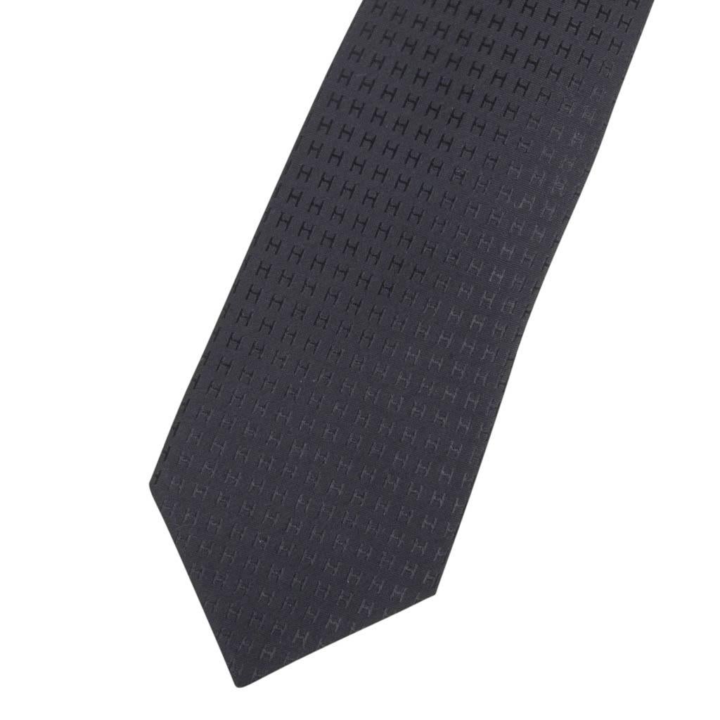 Guaranteed authentic Hermes black on black Faconnee H silk tie.
Sophisticated and chic this classic piece is a perfect addition to any wardrobe.
NEW or NEVER WORN
Comes with signature Hermes box. 
final sale

TIE MEASURES:
WIDTH 3.15