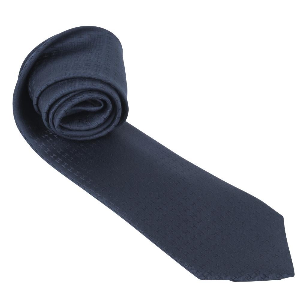Guaranteed authentic Hermes rich Marine Blue Faconnee H silk tie.
Sophisticated and chic this classic piece is a perfect addition to any wardrobe.
Tie width is 8 cm.
NEW or NEVER WORN
Comes with signature Hermes box. 
final sale

TIE MEASURES:
WIDTH