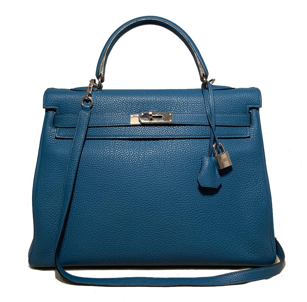 Gorgeous Hermes Togo Kelly Retourne 35 Cobalt Blue PDH in excellent condition. Limited edition cobalt blue togo leather exterior trimmed with silver palladium hardware. Matching leather shoulder strap, clochette with lock and 2 keys and twilly