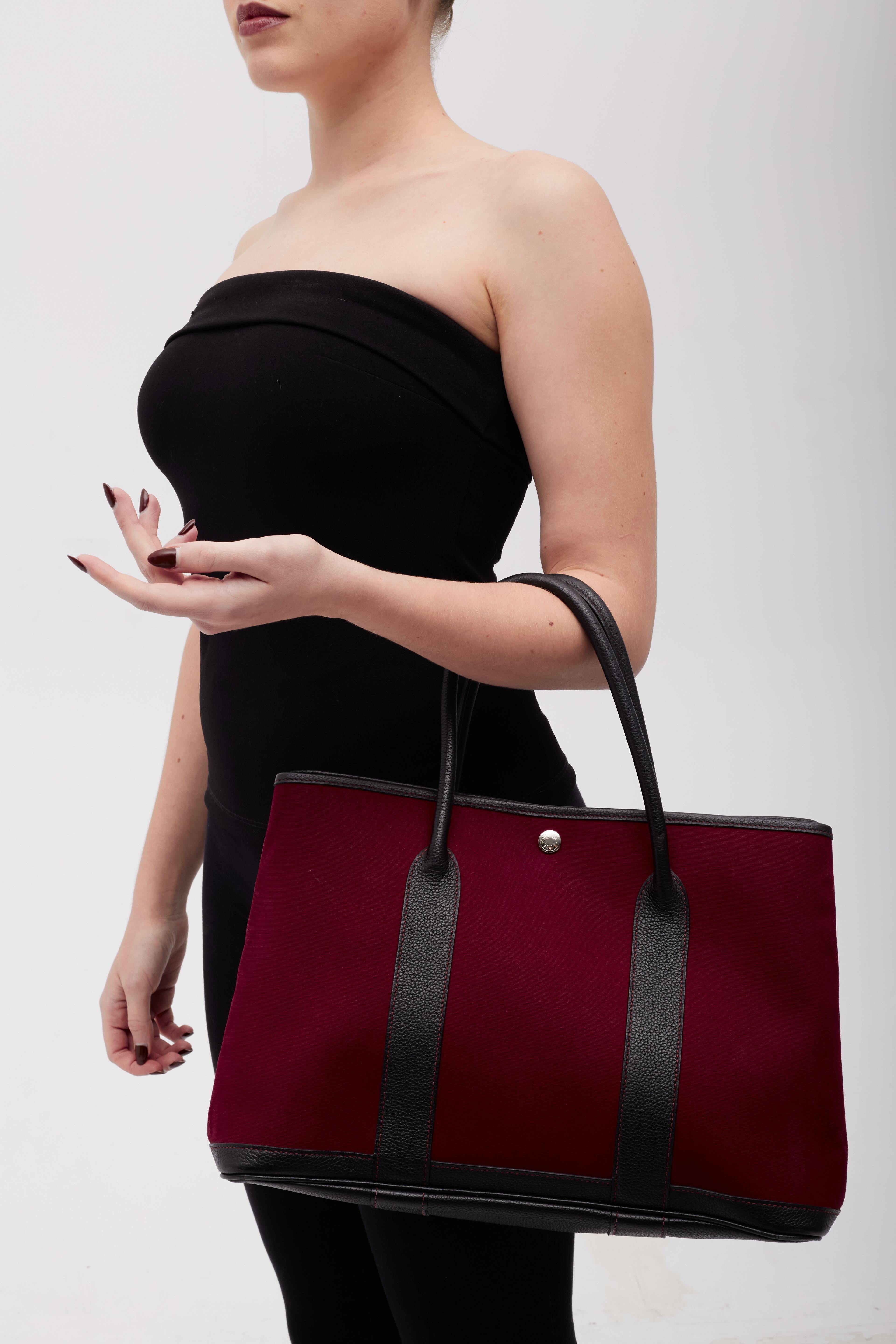 Color: red and black
Material: canvas with leather finishes
Condition: Very good. Faint hairline marks. Light residue.
Made in France

Measurements~
Height 13”
Width 16”
Depth 5”
Drop: 8”