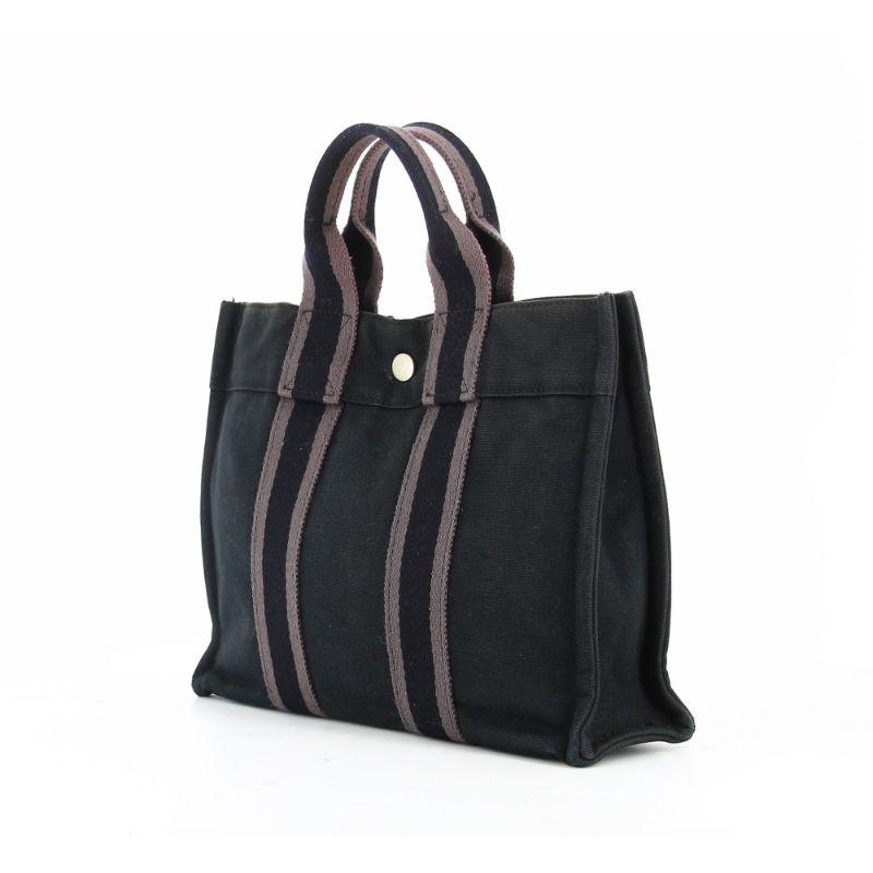 Hermes Toto Bag Black and gray

Very good condition, shows some wear with time.
Black canvas bag with gray and black stripes. It is a bag that has been designed for men and women.
Two very neutral colors, which can be worn and assembled with
