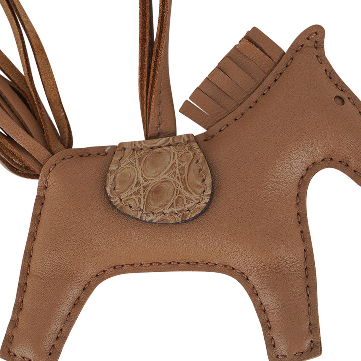 Mightychic offers a  limited edition Hermes Touch PM Rodeo bag charm featured in Chai.
Chai lambskin body, mane and tail is accentuated with matte Chai alligator. 
Charming and playful she easily adorns a myriad bag colors in your fabulous