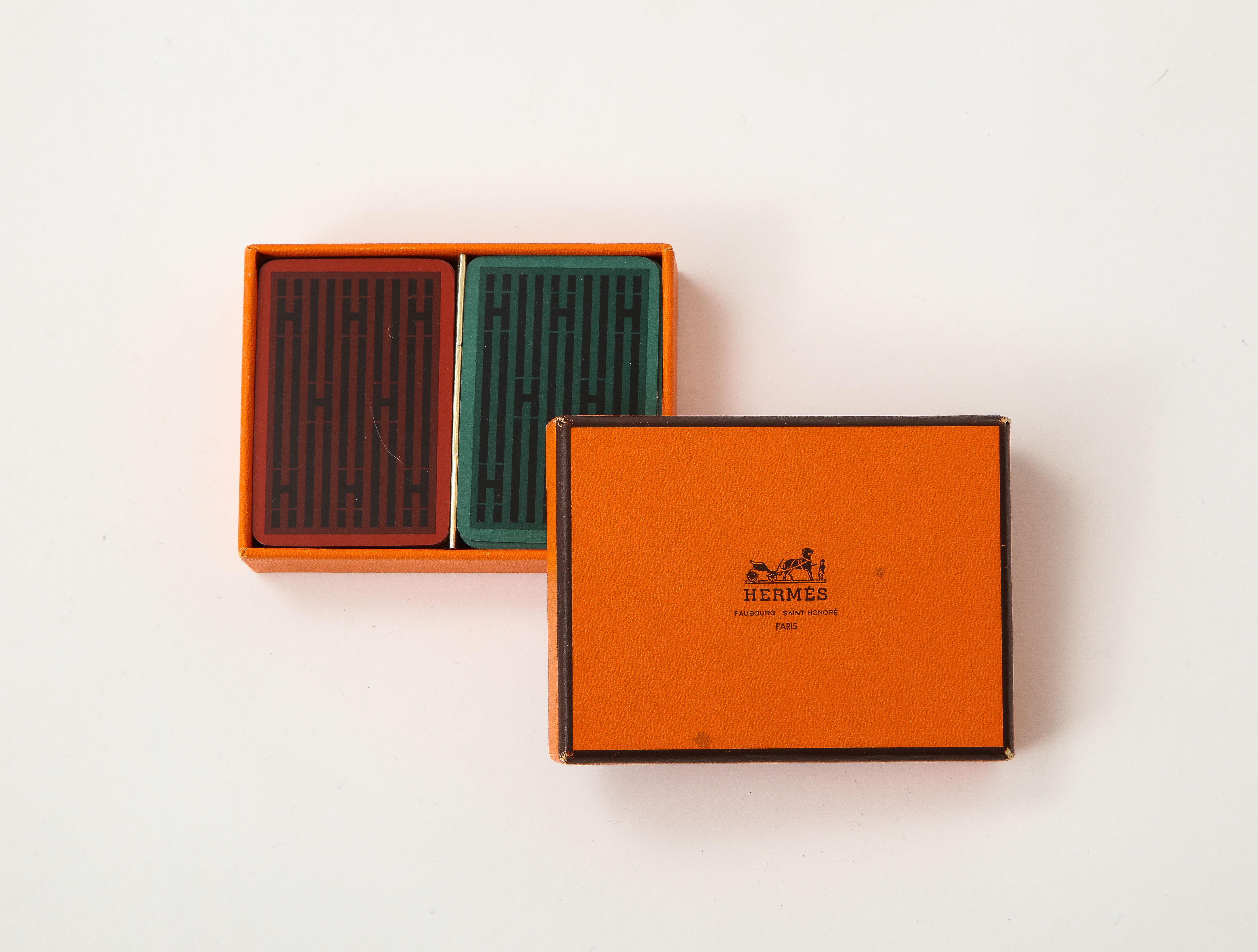 2 Decks of travel sized playing cards both featuring an abstracted graphic H pattern. Hermes, Paris.