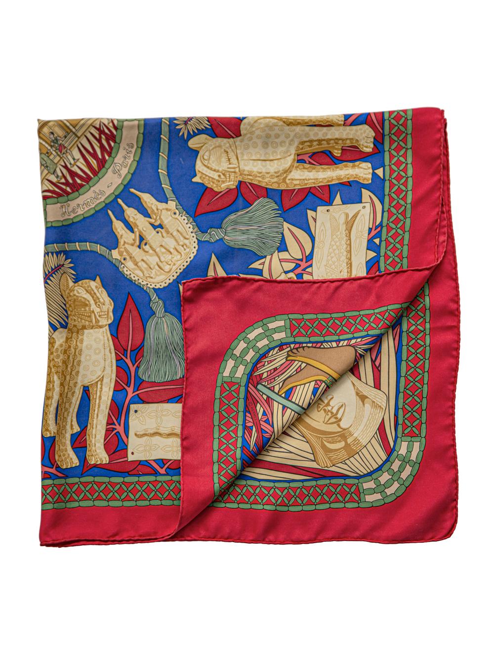 Crafted in France from the finest red silk, this pre-owned scarf by Hermès features lightweight construction, a square shape and print motifs. Designed by Sophie Koechlin for Hermes in 1997, this print celebrates the treasures of the Dohomey Kingdom