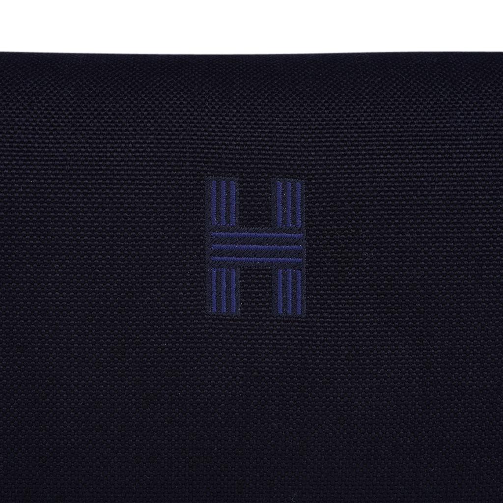 Mightychic offers an Hermes Trousse Bride-A-Brac cosmetic bag featured in Black cotton canvas.
Embroidered H on the front.
Top strap features a woven zig zag with White trim.
With two Clou de Selle snaps, the strap opens over a top zip with leather