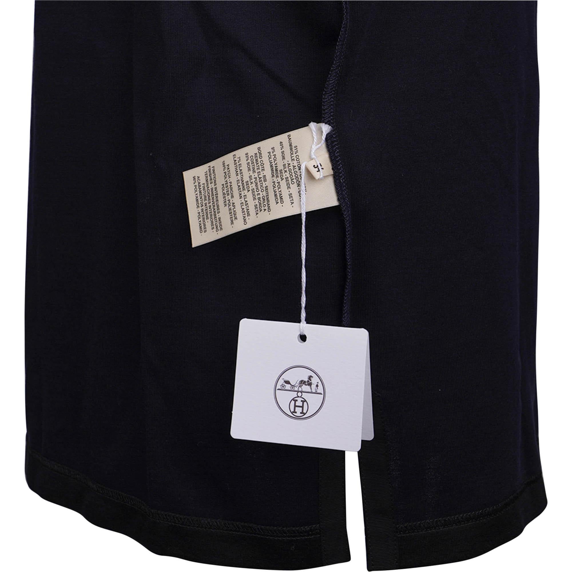 Mightychic offers an Hermes Tunique Fluide Tunic featured in Black.
A double jersey tunic.
Short sleeve with ribbed crew neck.
Embroidered tonal Clou de Selle patch.
A casual chic style from the beach to lunch.
Fabric is cotton, silk and nylon.
NEW