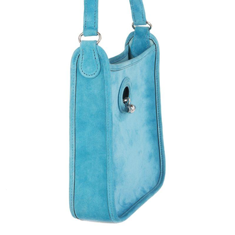 Hermès 'Vespa Velours Doblis' bag in turquoise suede. Opens with a long, Palladium piece which inserts into a buttonhole and functions as a clasp. Lined in turquoise calf leather. Has been worn with minor signs of use. Comes with box, dust bag and