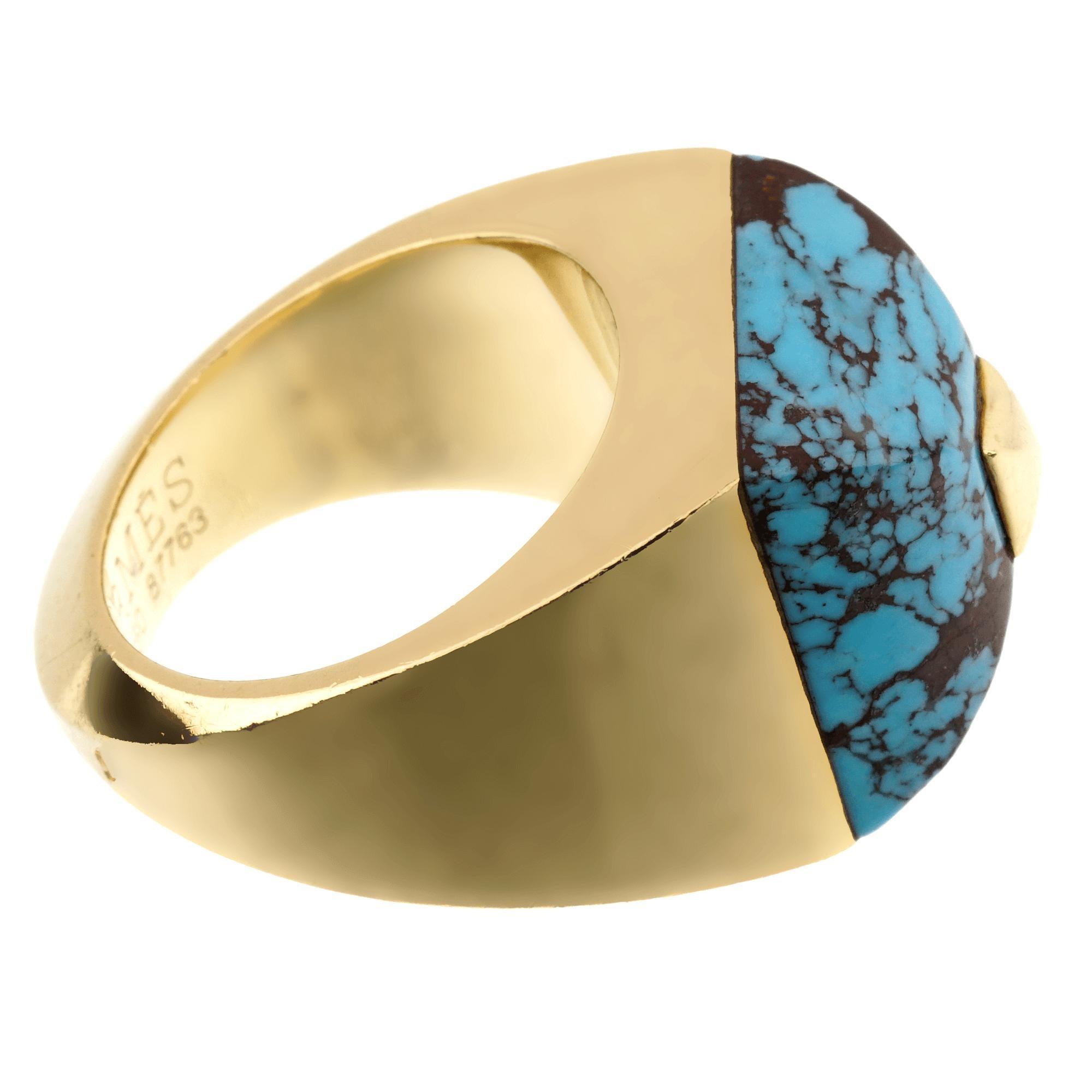 An extremely rare Hermes cocktail ring showcasing an amazing carved turquoise topped with a gold pyramid in 18k yellow gold. 

The ring measures a size 53, 6 1/2 us and can be resized if needed.