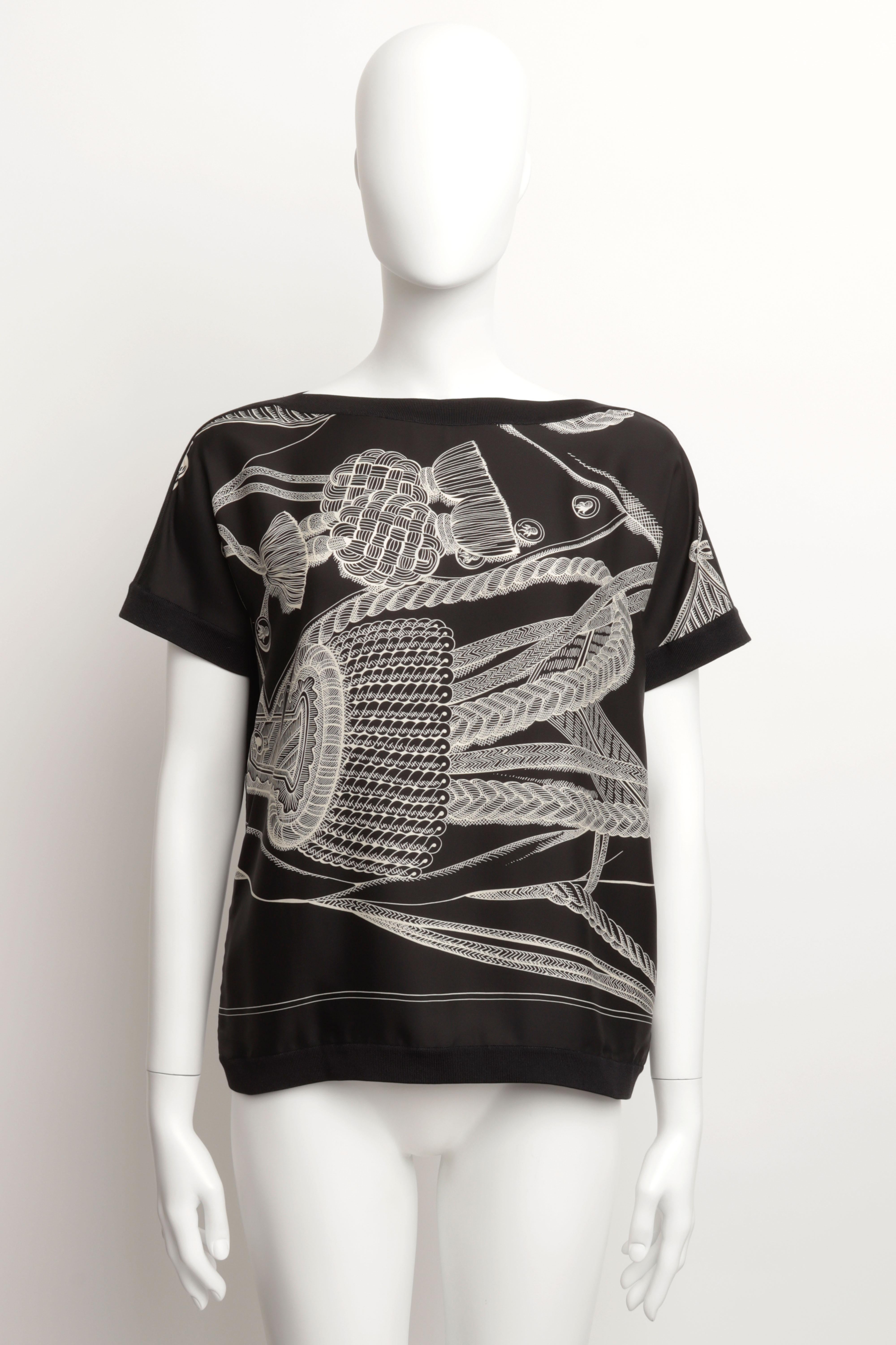 HERMES TWILLAINE TOP À MANCHES COURTES EN SOIE NOIRE IMPRIMÉE TAILLE 40 FR

Emblème du savoir-faire d'Hermès, la twillaine est idéale pour créer des superpositions sophistiquées. Méticuleusement confectionnée selon la technique du greffage, cette