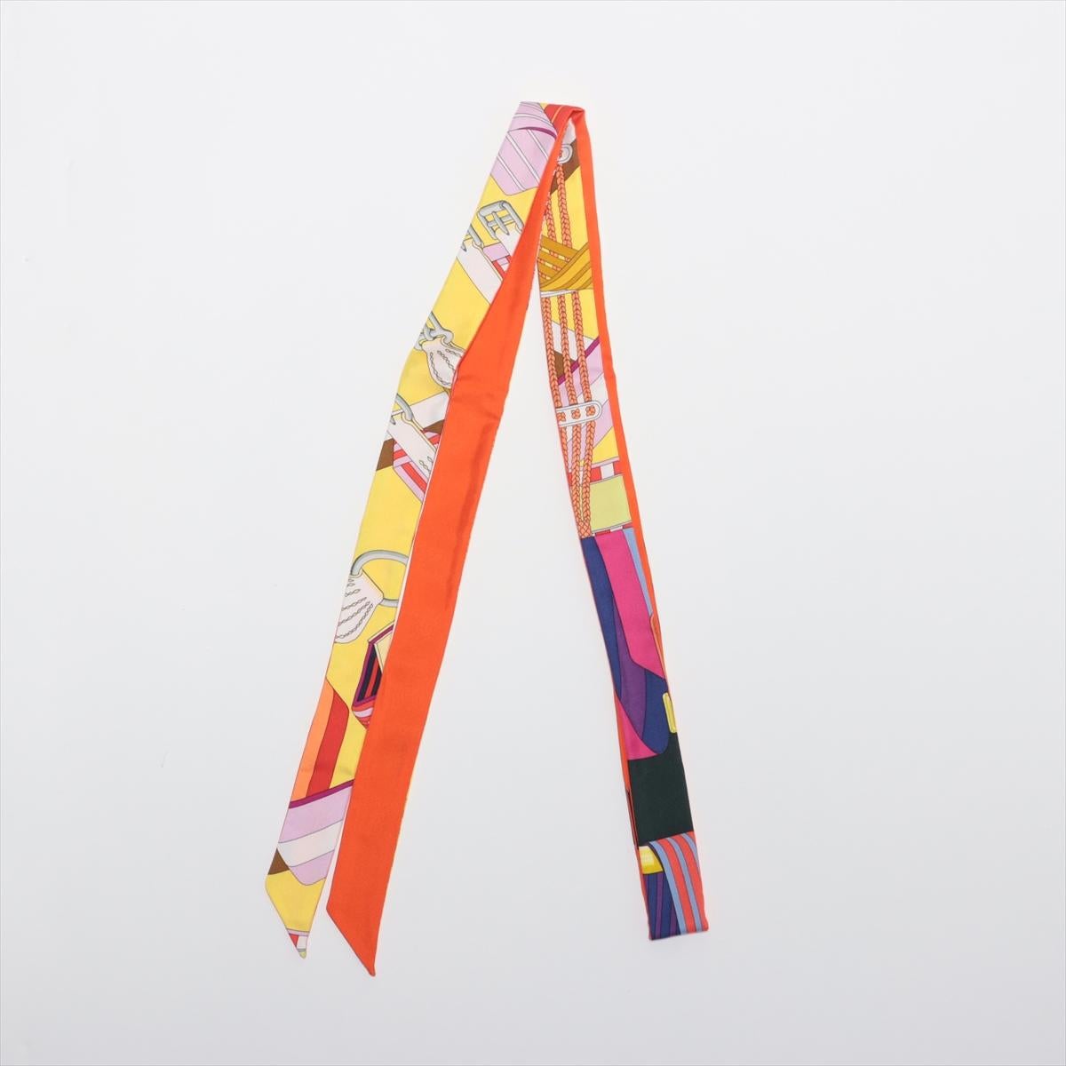will ship about 4/1
The Hermès Twilly Silk in Multicolor Orange is a vibrant and versatile accessory that showcases Hermès’ exquisite craftsmanship. Made from luxurious silk, the slim and elongated design features a bold multicolor pattern with
