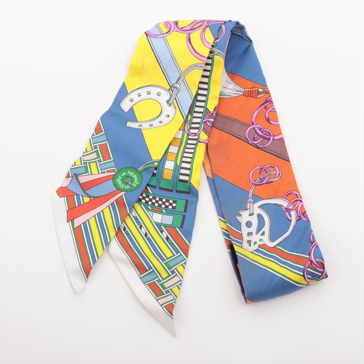 will ship about 4/1


The Hermès Twilly Brides et Gris Gris Silk in Blue x Orange x Yellow is a vibrant and elegant accessory that showcases Hermès' signature equestrian-inspired design. Crafted from luxurious silk, the Twilly features intricate