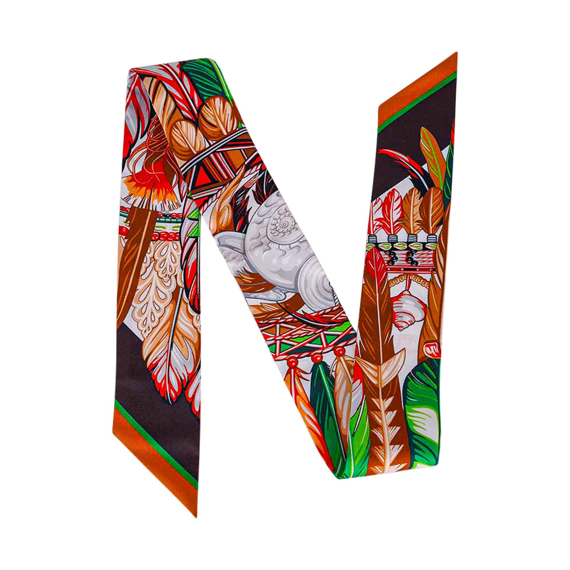 Mightychic offers a guaranteed authentic Hermes Twilly Danse Pacifique set of two (2) featured in Vert  Vif / Corail / Brun.
Designed by Laurence Bourthoumieux, Danse Pacifique pays homage to the culture of New Guinea.
This iconic Hermes accessory