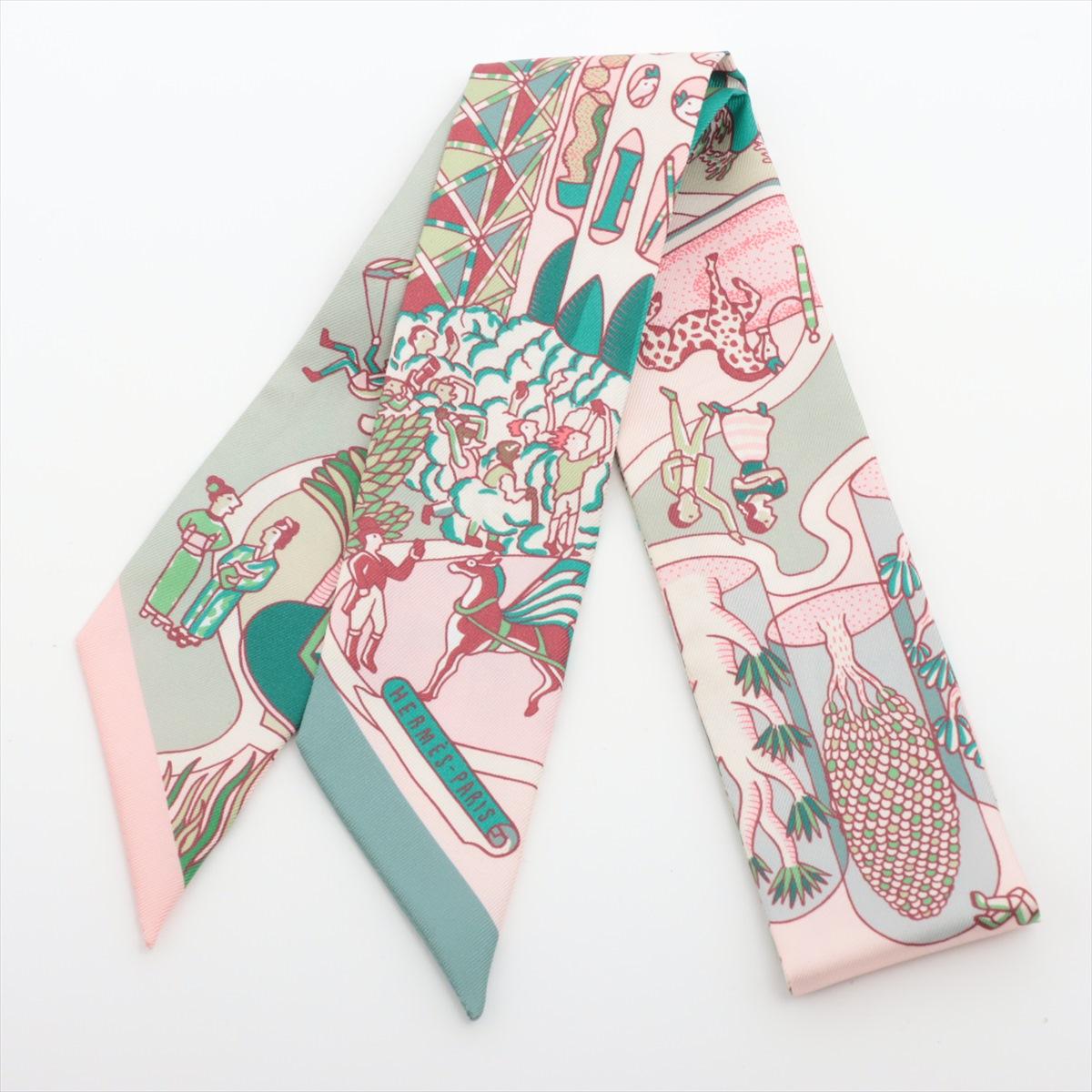 The Hermès Twilly Exposition Universelle World Silk is a luxurious and versatile accessory that embodies the brand's heritage and craftsmanship. Crafted from fine silk twill, the Twilly scarf features a captivating design inspired by the Exposition