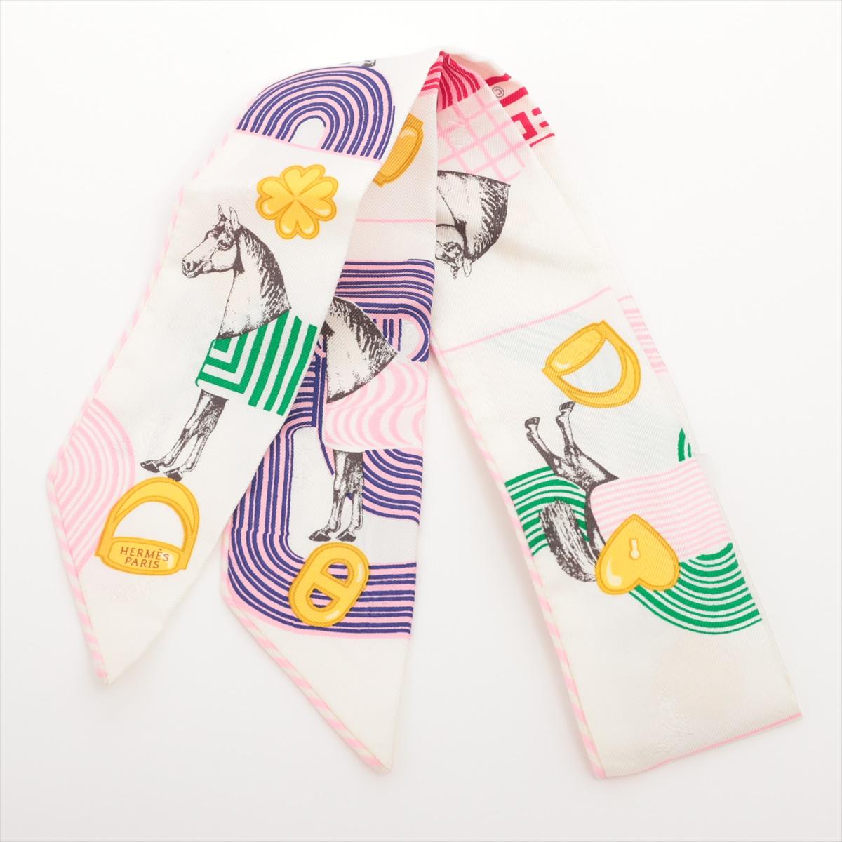 The Hermès Twilly Garde Robe Pop Silk in White x Multicolor Print is a chic and versatile accessory that adds a playful yet sophisticated touch to any outfit. Crafted from luxurious silk, the Twilly features a vibrant multicolor print inspired by