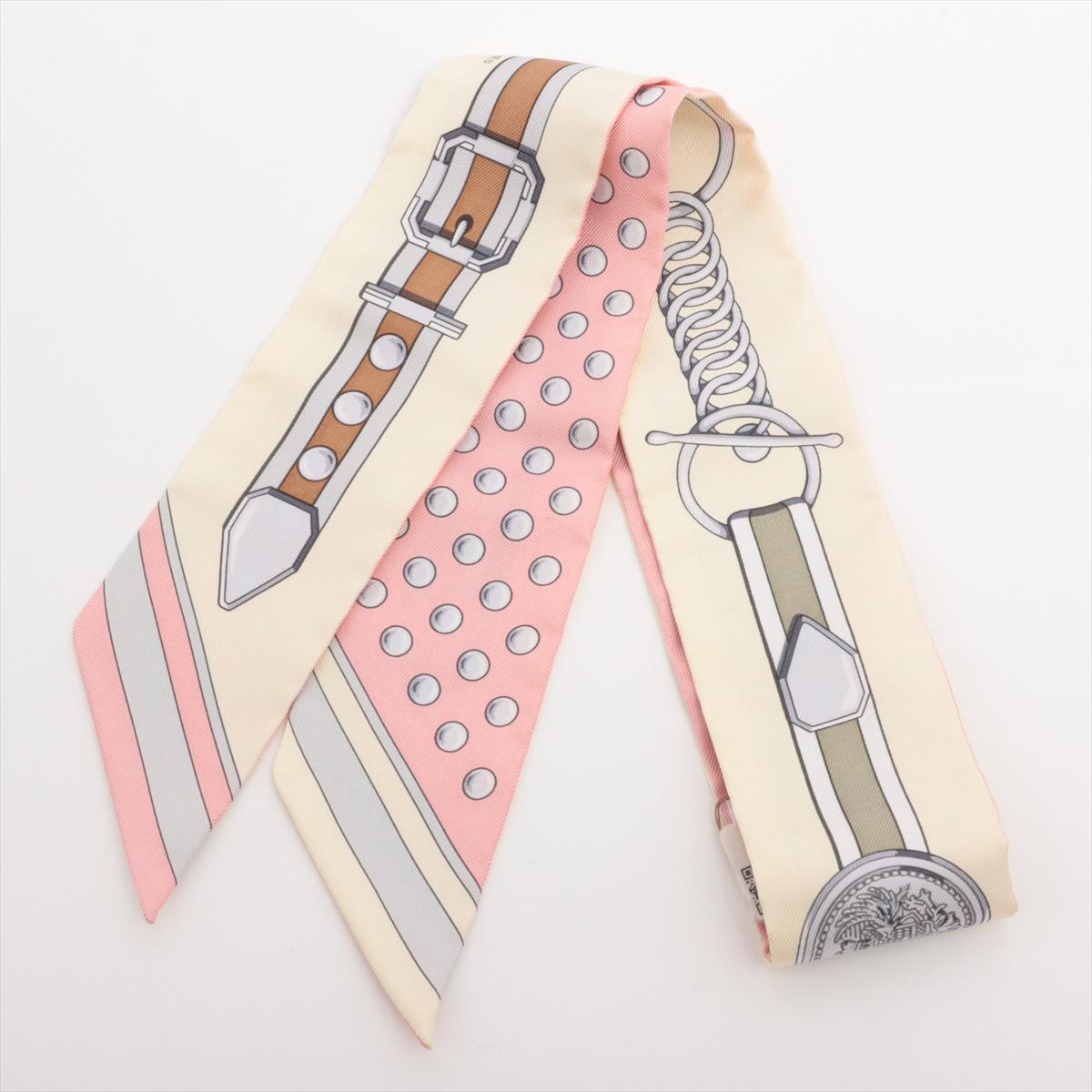 The Hermès Twilly Grand Tralala Silk Scarf in pink is a charming and versatile accessory, featuring an intricate design inspired by whimsical elegance and artistry. Made from luxurious silk, its vibrant colors and detailed patterns bring