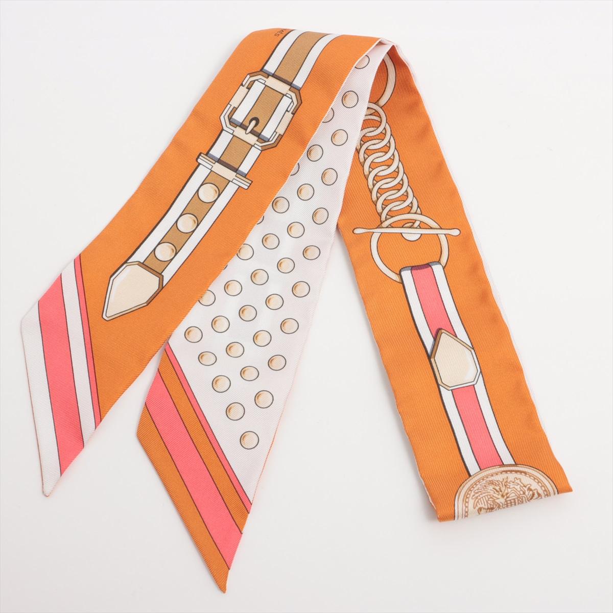 The Hermès Twilly Grand Tralala Silk in Orange is a vibrant and playful accessory, offering a bold splash of color to elevate any outfit. Made from 100% silk, the Twilly features intricate patterns and designs that reflect Hermès' artistic