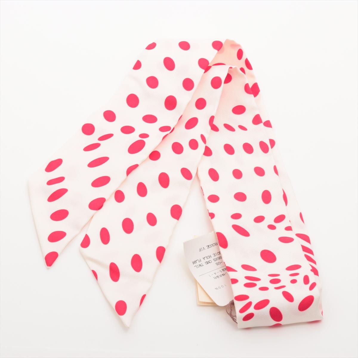 *will ship about 3/10

The Hermès Twilly Hola Flamenca in White and Red is a vibrant and elegant silk accessory that adds a playful touch to any look. Featuring a lively polka dot pattern inspired by the passion and movement of flamenco dance, the