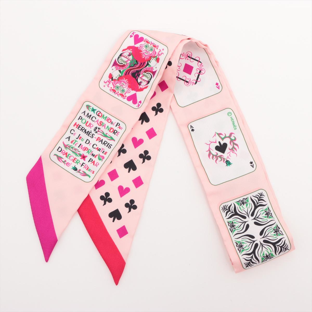 The Hermès Twilly Jeu de Cartes in Pink is a playful and artistic silk accessory inspired by the whimsical world of playing cards. Featuring intricate illustrations of card suits, characters, and decorative motifs, the design brings a sense of fun