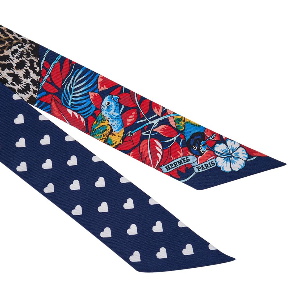 Guaranteed authentic Hermes Twilly features set of 2 limited edition Jungle Love Love featured in rich Blue Marine and Red.
White Hearts sprinkled against the Blue background.
This iconic Hermes accessory can be worn in a myriad ways to add a