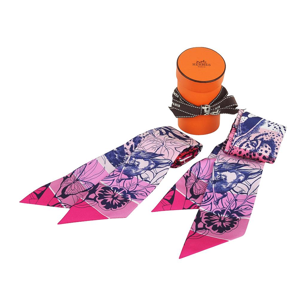 Guaranteed authentic Hermes silk scarf Jungle Love Rainbow Twilly set designed by Robert Dallet.
Lovely tones of Rose / Vert / Encre.
Comes with signature Hermes box and ribbon.
NEW or NEVER WORN
final sale

TWILLY MEASURES: 
32