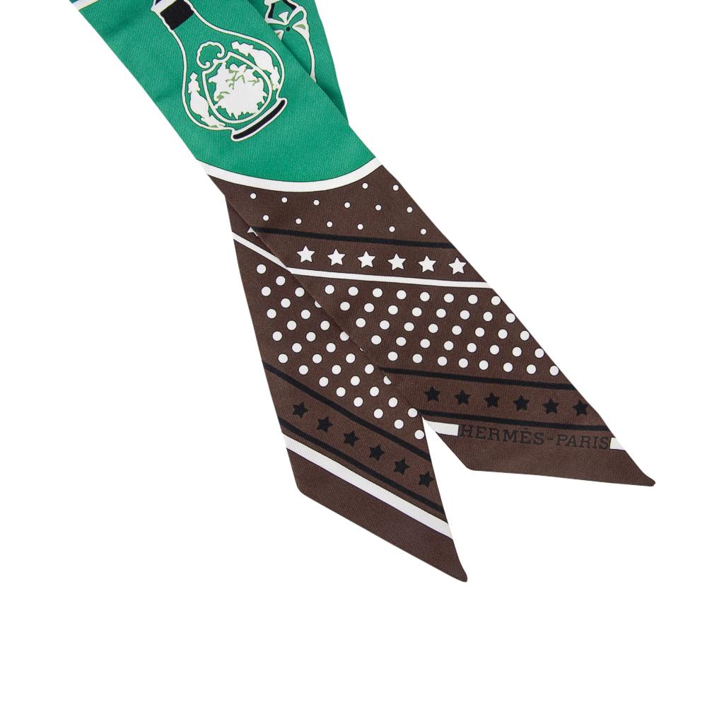 Guaranteed authentic Hermes Twilly silk scarf set of 2  Les Flacons Bandana features Marron, Vert and Blanc.
This iconic Hermes accessory can be worn in a myriad ways to add a playful touch to your wardrobe.
And of course express your own