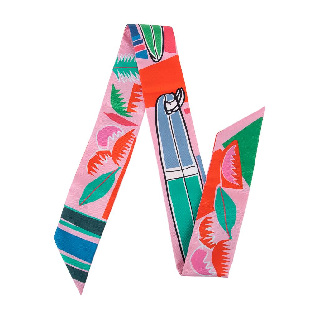 Guaranteed authentic Hermes Twilly Sea Surf and Fun by Felipe Jardim.
Vibrant fresh summer colors features Rose, Menthol and Vermillion. 
Perfect and fresh! 
Tropical palms and surfboards.
This iconic Hermes accessory can be worn in a myriad ways to