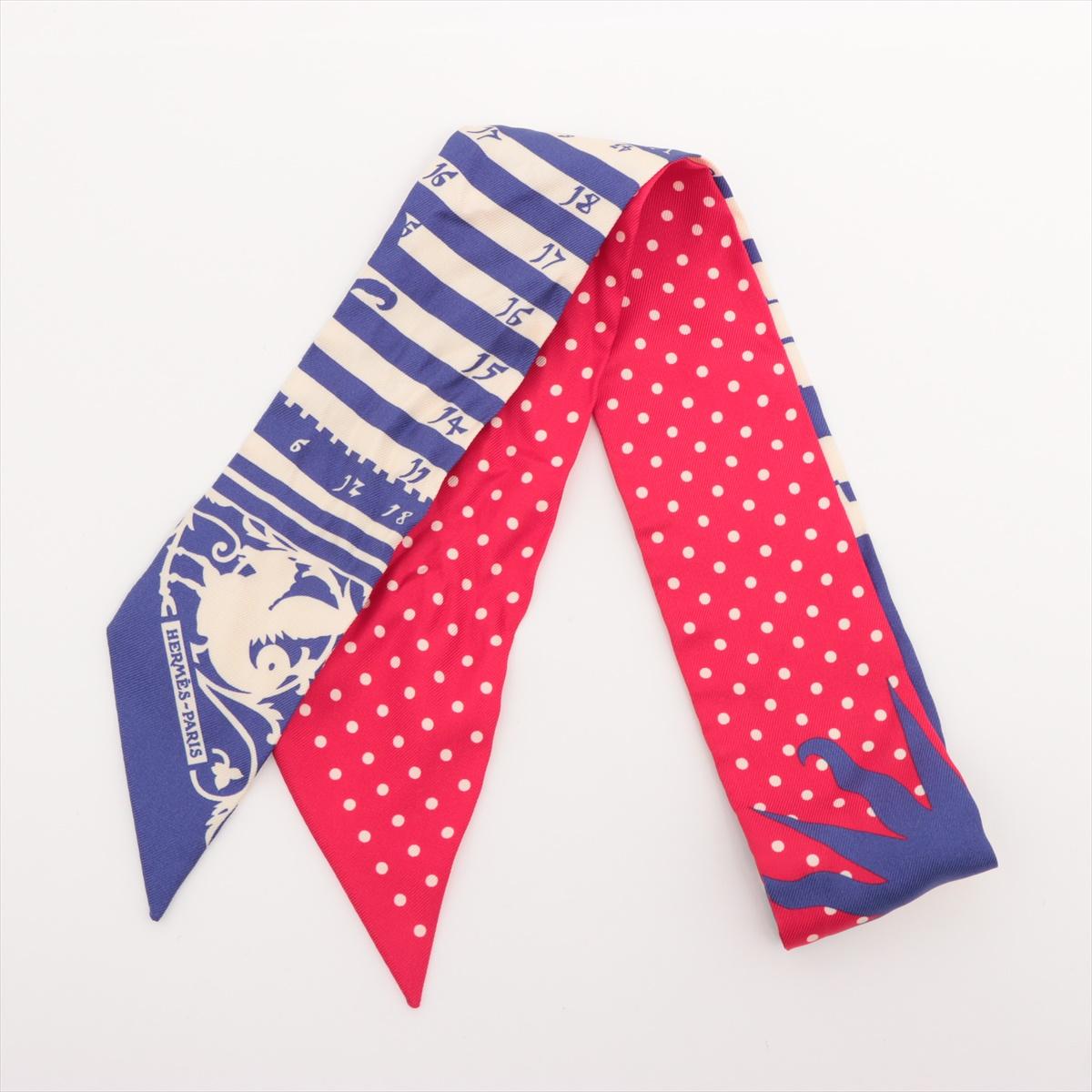 The Hermès Twilly Astrologie à Pois in Blue x Red is a vibrant and imaginative silk accessory that blends celestial elegance with playful charm. Featuring a reinterpretation of the classic Astrologie, the Twilly showcases cosmic elements overlaid