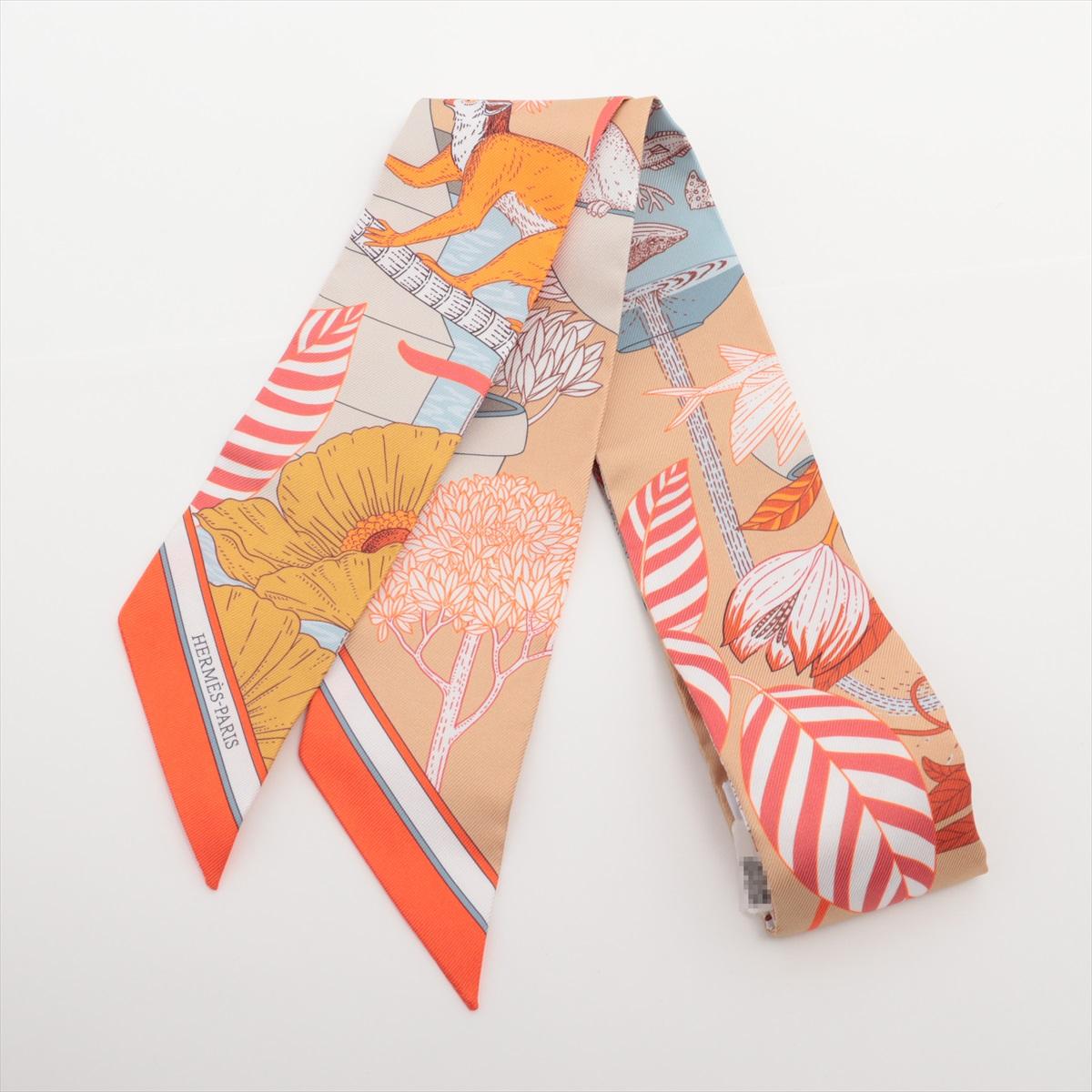 The Hermès Twilly Silk Precious Paradise Scarf in Orange is a vibrant and elegant accessory that showcases the brand’s signature craftsmanship and artistic design. Made from 100% silk, the slim and versatile scarf features an intricate Precious