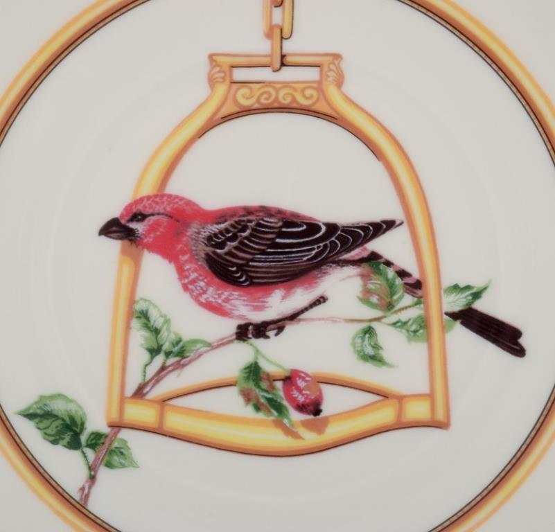 French Hermès. Two porcelain plates with bird motifs. 