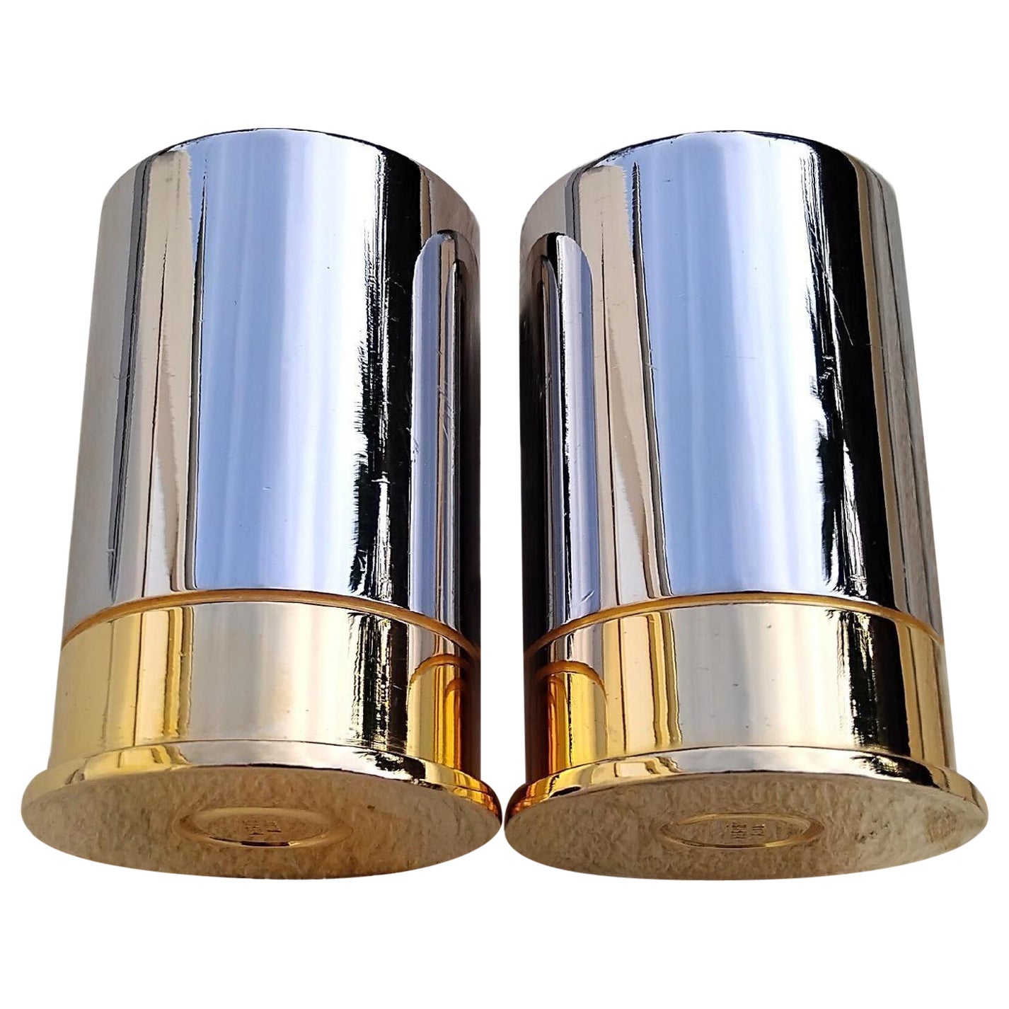 Rare Authentic Hermès Set of Two Shooter Glasses

In shape of shotgun cartridges

Can be used as a shot glass or toothpick holder, or just as decoration

Vintage Items
 
The body is in silver metal and base in golden metal 

