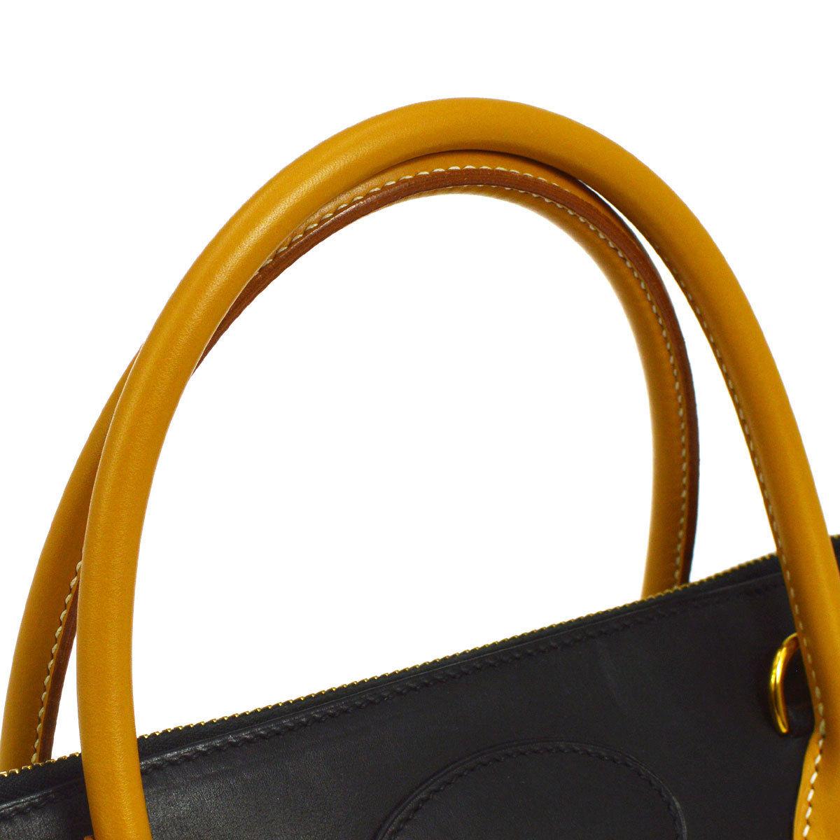 Hermes Two-Tone Black Cognac Leather Gold Top Handle Satchel Travel Weekend Tote

Leather
Gold tone hardware
Date code present
Made in France
Handle drop 4