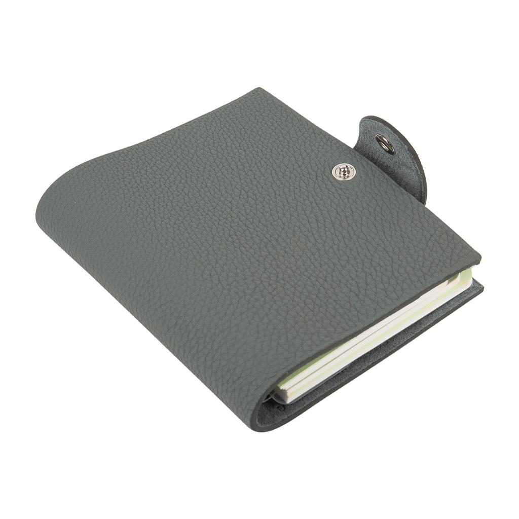 Guaranteed authentic Hermes Ulysse mini model notebook cover features Vert Amande in Togo leather.
Palladium Clou de Selle snap. 
Comes with a new Ulysse unlined notebook refill.   
Each item comes with the signature Hermes box and ribbon.
New or