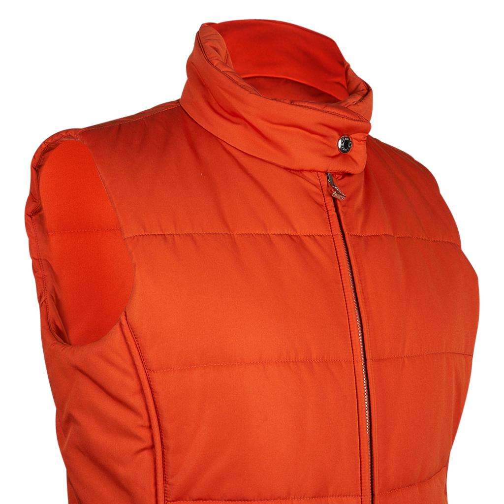 Mightychic offers an Hermes Orange unisex Jockey puffer vest.
Insulating sleeveless vest with 2 side zip pockets.
Double toggle zipper front with logo pull.
High neck with snap closure and Clou de Selle.
1 inside zip pocket.
Interior tag Hermes