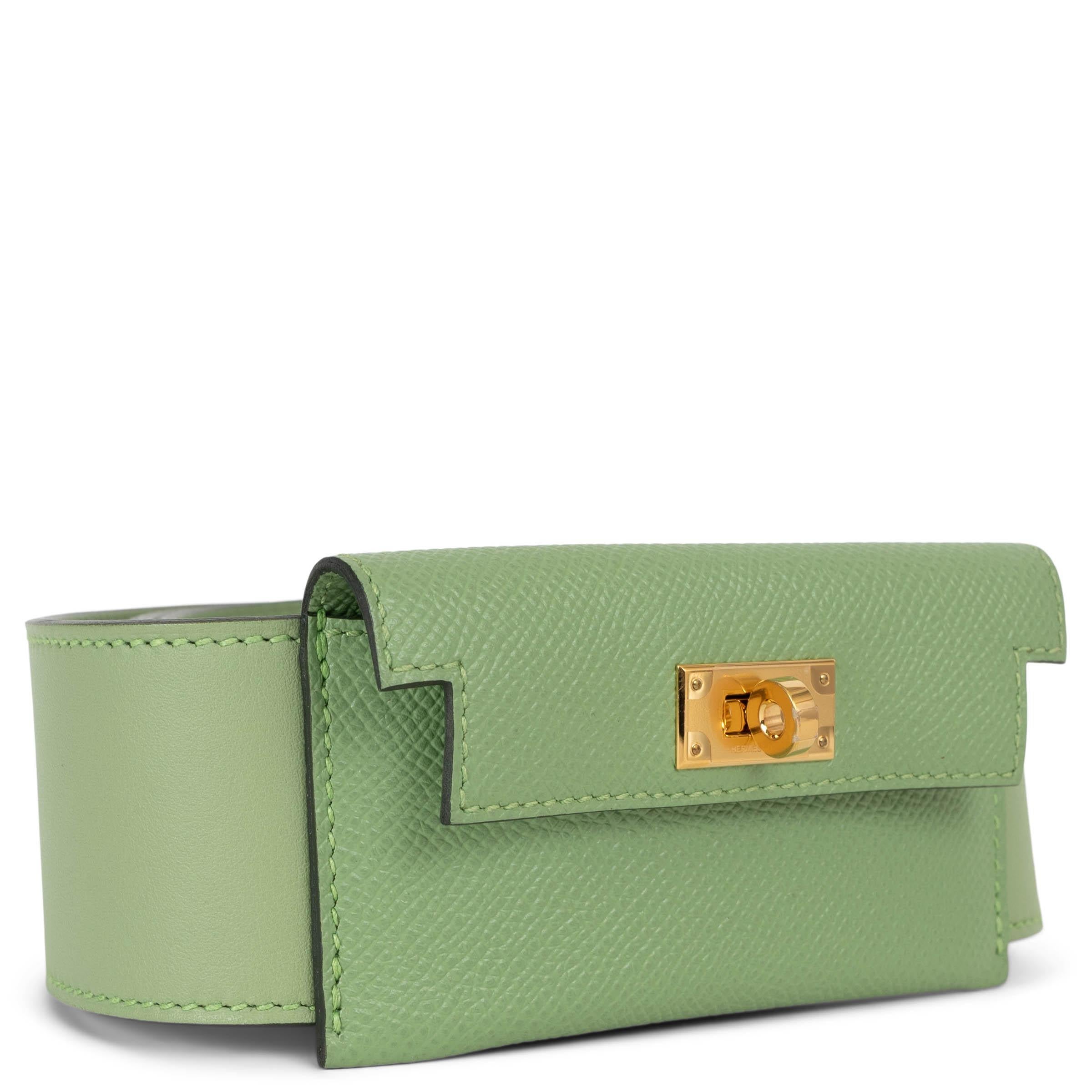 This 100% authentic Hermès Kelly Pocket bag strap in Vert Criquet (pastel green) Veau Swift leather is a striking blend of style and utility. It features a bold flap pocket crafted in matching Veau Epsom leather, secured with the house’s iconic