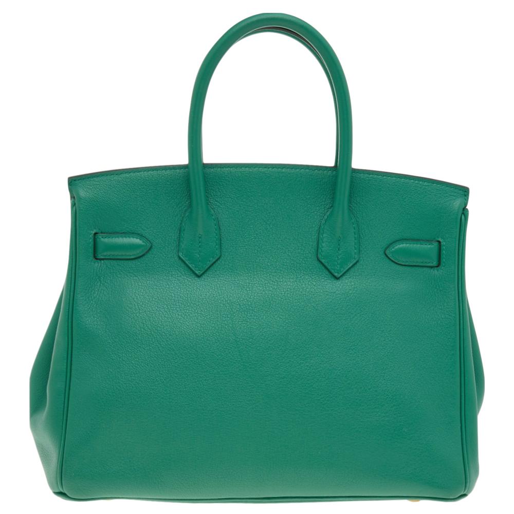 If you've been wishing to own an authentic Birkin bag, there is no better time to buy this coveted work of art than now. Here, we have this Vert Vertigo Evercolor Birkin 30 just for you. Crafted in France, the bag features dual top handles and a