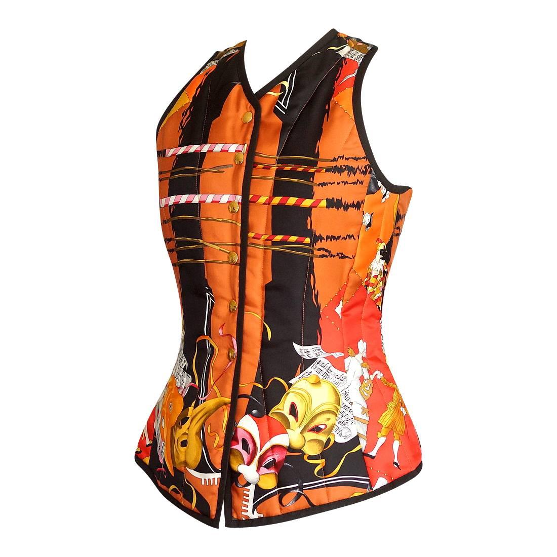 Mightychic offers a vintage Hermes Carnavale De Venise scarf print beautifully shaped vest.
The exquisite shapes and stunning colors of the Venetian Carnaval.
V-neck with 6 gold embossed snaps and brown piping all around.
Gentle wadding.
Beautiful
