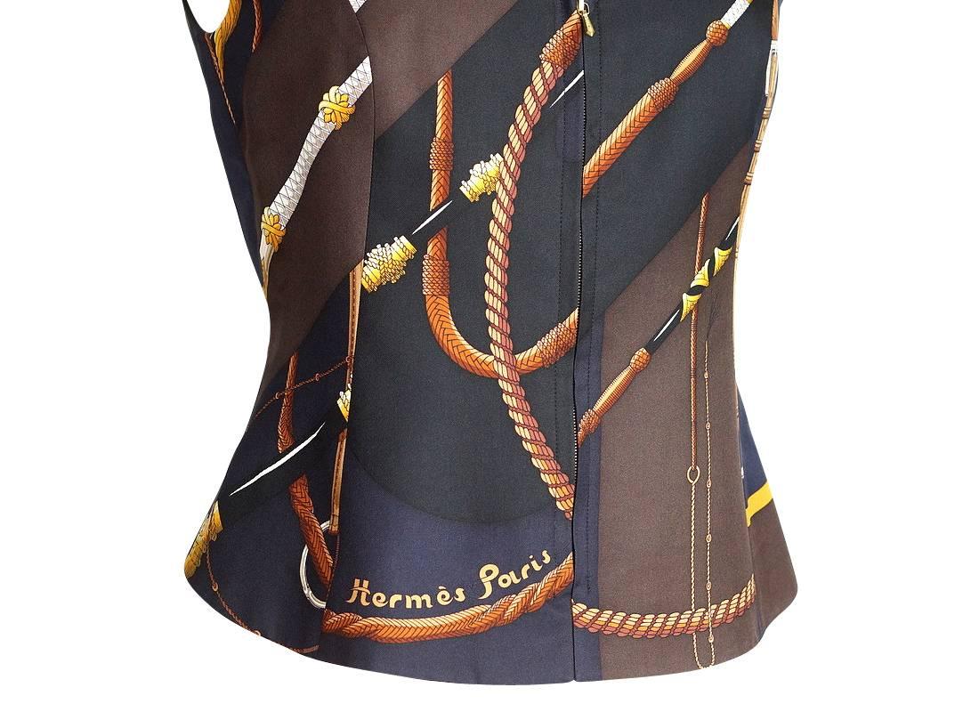 Mightychic offers a guaranteed authentic Hermes scarf print Clic Clac vest. 
Chic in brown navy and black.
Small lapels - each in a different colour.
2 buttons on each side of rear 'tab'.
Hidden zipper closure.
Fabric is silk.
Superb!
final