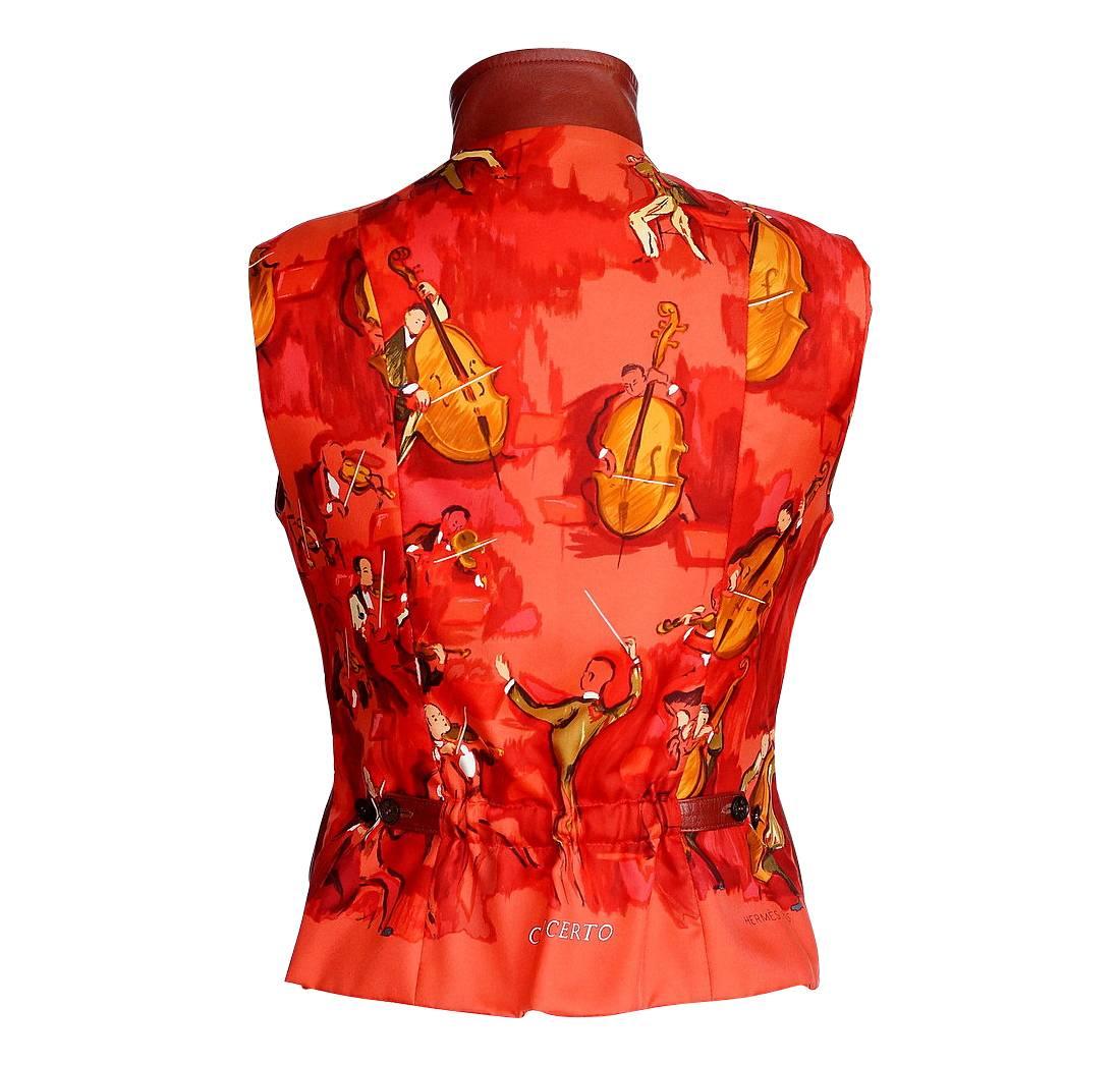 Guaranteed authentic Hermes vintage silk scarf print Concerto and leather vest. 
Rich cordovan red lambskin front with Concerto scarf print rear.
The print depicts an orchestra in rich shades of red, orange and brown.
Vest has high and zip front