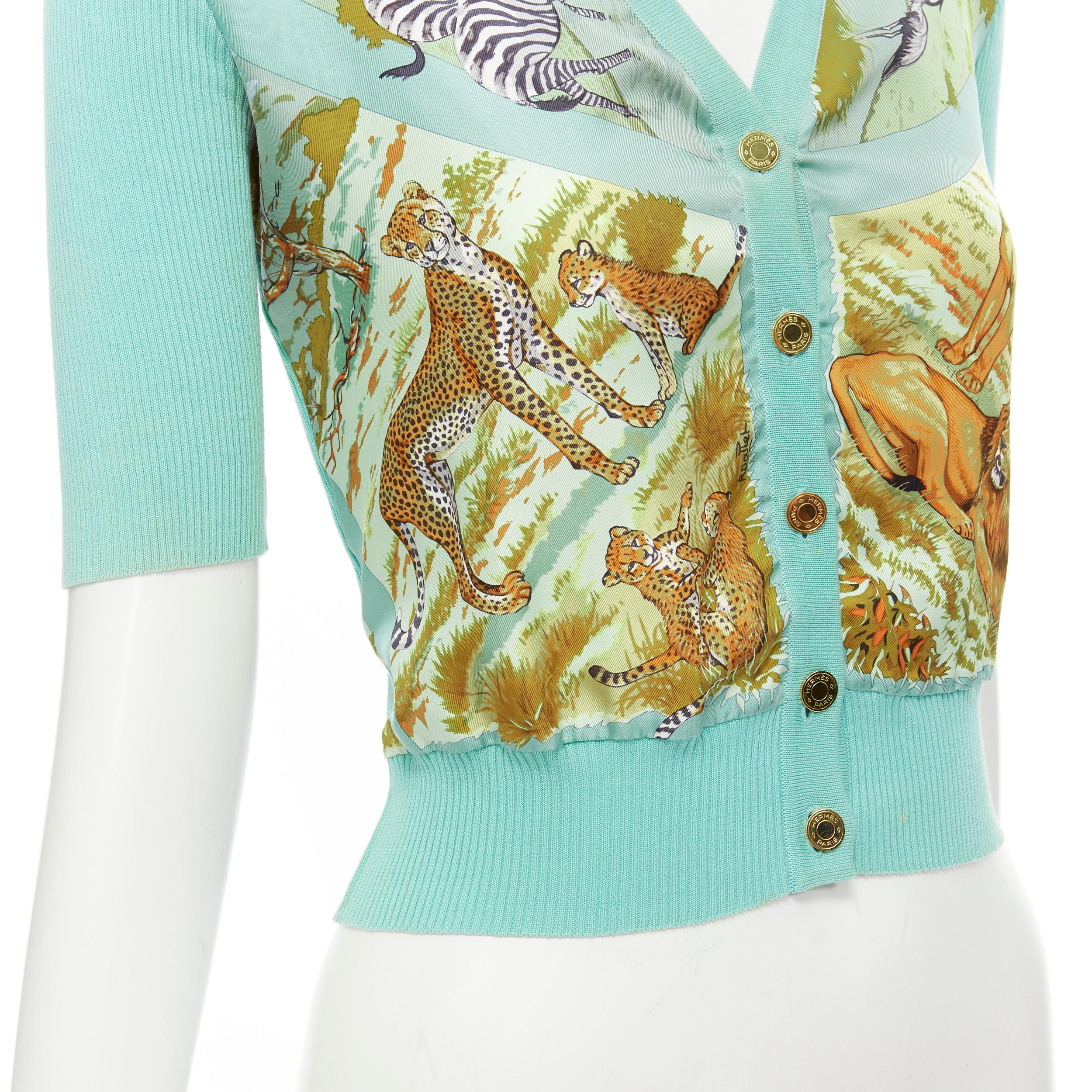 HERMES Vintage 100% silk animal print teal blue ribbed cotton cardigan FR38 M 
Reference: GIYG/A00199 
Brand: Hermes 
Material: Silk 
Color: Blue 
Pattern: Animal 
Closure: Button 
Extra Detail: Gold-tone Hermes logo button. 100% silk print panel.