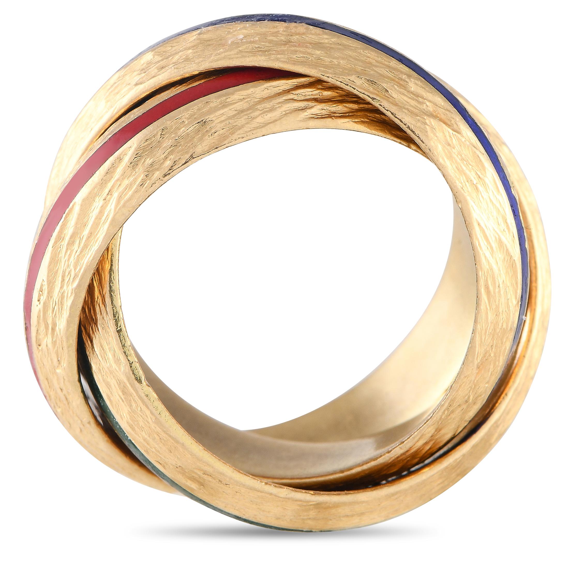 A must-have for your vintage jewelry collection. This extraordinary piece from Hermès presents three solid gold bands intertwined to form a single ring. Each 18K yellow gold band has a textured finish and an enameled ribbon accent - in red, green,