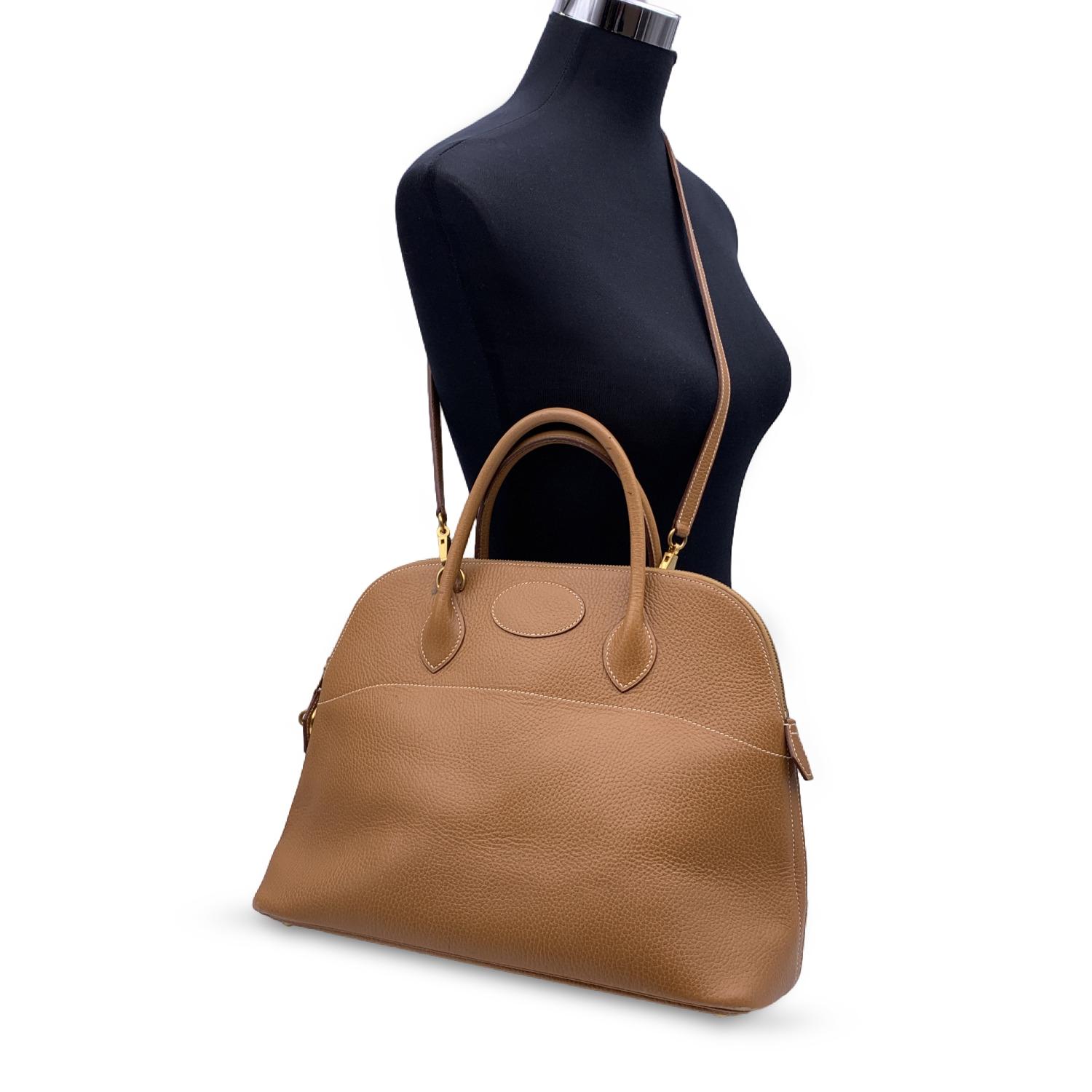 Sophisticated and timeless Hermes BOLIDE BAG crafted in beige leather (Chamonix leather in Cognac color) from the 1994 (blind stamp is 'X' encased in a circle). It features a doomed top with double top rolled leather handles and removable shoulder